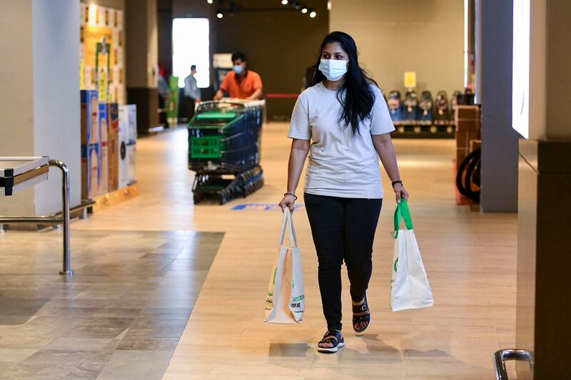 Shoppers look for savings in weekly grocery shopping.  Khushnum Bhandari / The National