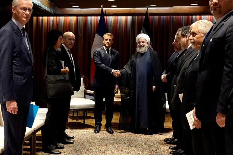 President Hassan Rouhani, right, shakes hands with French President Emmanuel Macron during their meeting on the sidelines of the United Nations General Assembly.  AP