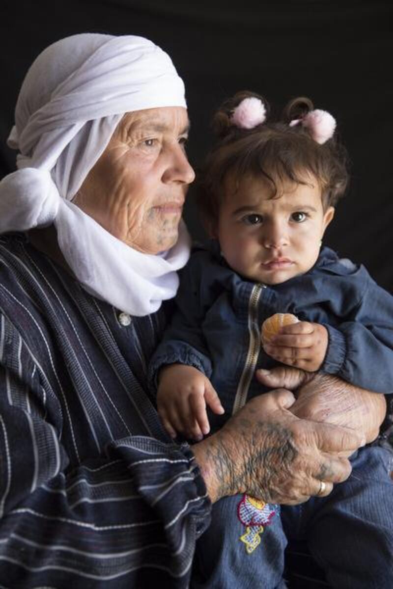 Mayre Hame, 65 or 66 year-old woman from Bir Rame, a village of Kobani, with her one-year- old granddaughter Lina. She is the mother of 11 children. ‘My mother died when I was just 10 years old. Me and my three sisters all got tattoos. I was scared.’