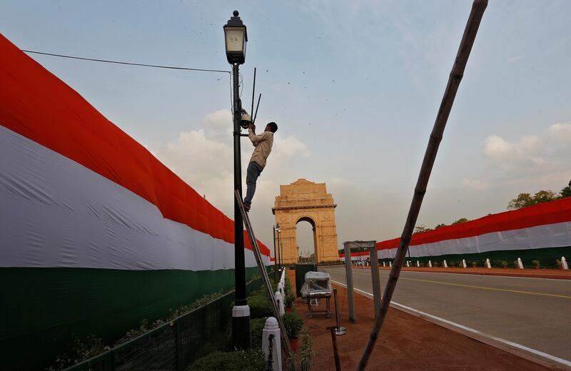 A worker fixes a lamp post in front of the India Gate on the eve of Independence Day celebrations in New Delhi. Adnan Abidi / Reuters