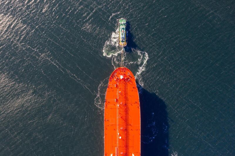 A tug boat tows an LNG vessel in Geoje, South Korea. Bloomberg