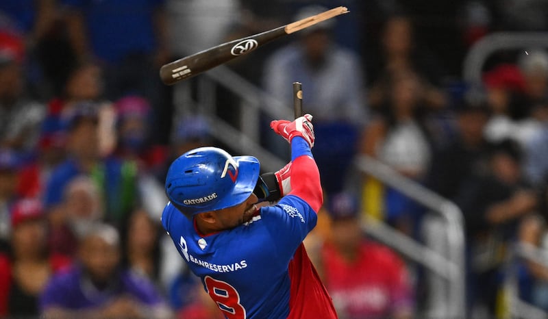 Webster Rivas of the Dominican Republic breaks the bat as he hits a ball, during his side's Caribbean Series baseball championship game against Venezuela, in Miami. AFP