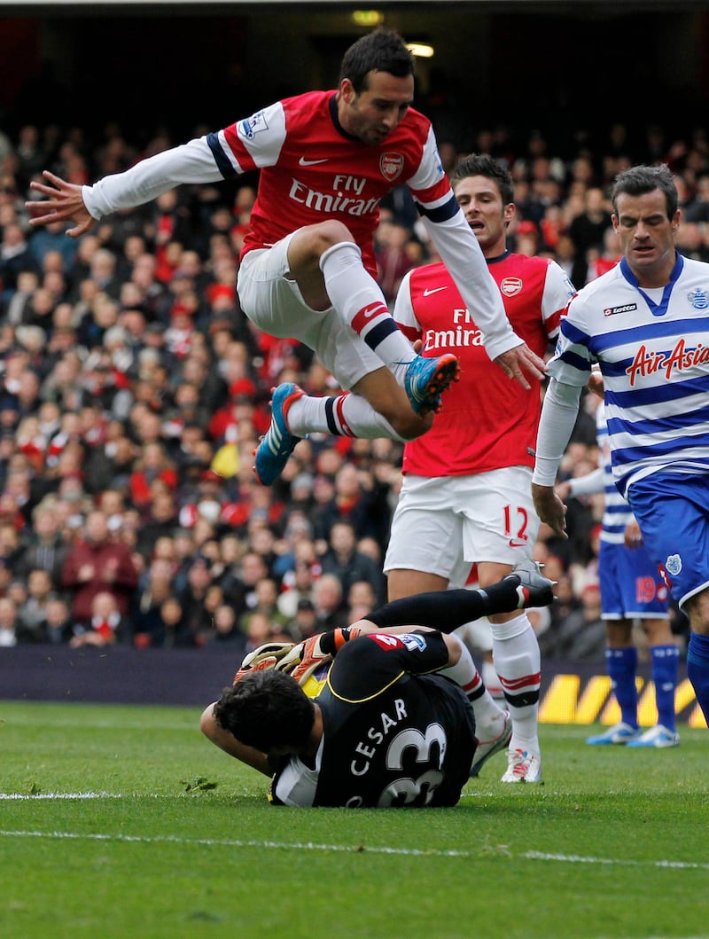 Arsenal's Santi Cazorla, top, jumps over a tackle from Queens Park Rangers' goalkeeper Julio Cesar during their English Premier League soccer match at Emirates stadium, London, Saturday, Oct. 27, 2012. (AP Photo/Sang Tan) *** Local Caption ***  Britain Soccer Premier League.JPEG-0964a.jpg