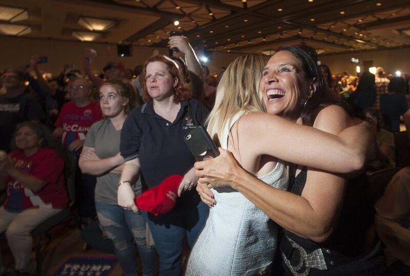 Supporters of Republican presidential candidate Donald Trump, Stephanie Meza, 42, of Scottsdale, Arizona, and Rhonda Davis, 63, of Scottsdale, Arizona hug as election results come in.  Laura Segall / AFP