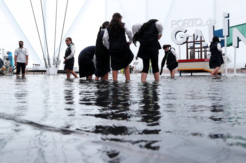 Visitors dipping their feet in the water at the Brazil pavilion. Pawan Singh/The National