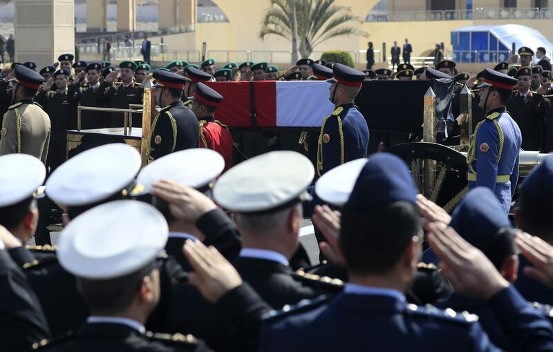 Egyptian honour guards carry the coffin of former president Hosni Mubarak. AFP