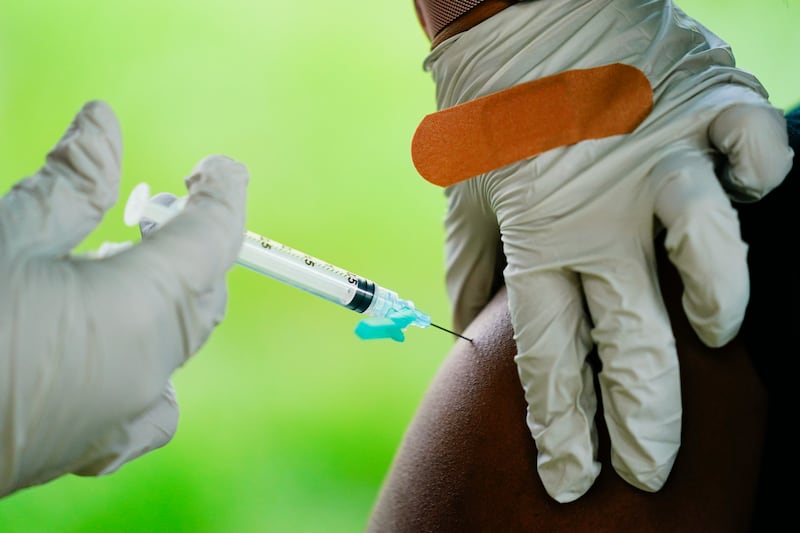 A health worker administers a dose of a Pfizer Covid-19 vaccine at a clinic. AP