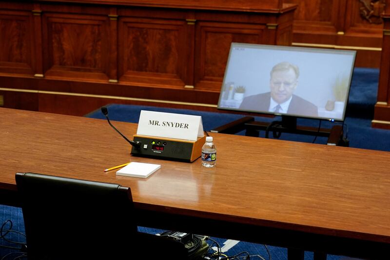 An empty seat for Washington Commanders co-owner Dan Snyder, who declined to appear, is seen as NFL commissioner Roger Goodell testifies by video. Reuters