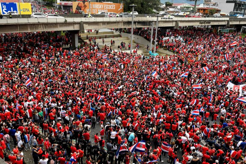 Costa Rica fans celebrate after their nation became the last team to qualify for this year's World Cup. AFP