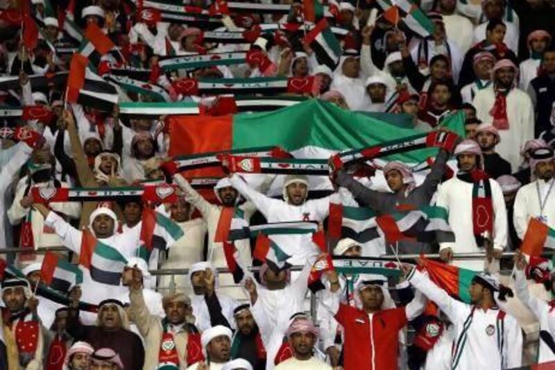 UAE supporters cheer the team on during their opener against Qatar in Isa Town on Saturday. Fadi Al-Assaad / Reuters