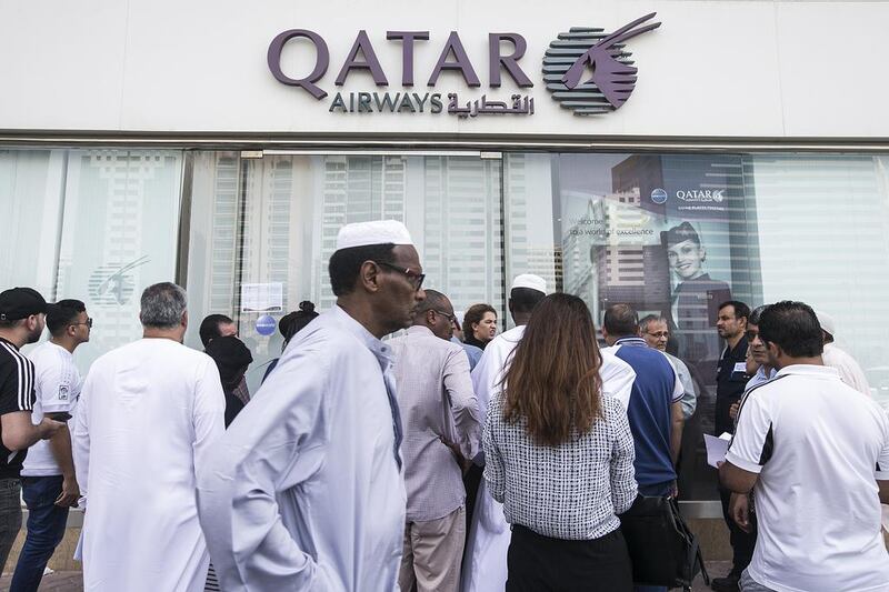 People queue outside the Qatar Airways office in Abu Dhabi. Mona Al Marzooqi / The National