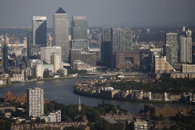 The Canary Wharf business, financial and shopping district, top, stands beyond the River Thames seen from the Leadenhall Building. Within the office sector, central London experienced the strongest rental value growth, at 11.4 per cent in 2014 compared with 8.1 per cent for the rest of the UK. Simon Dawson / Bloomberg