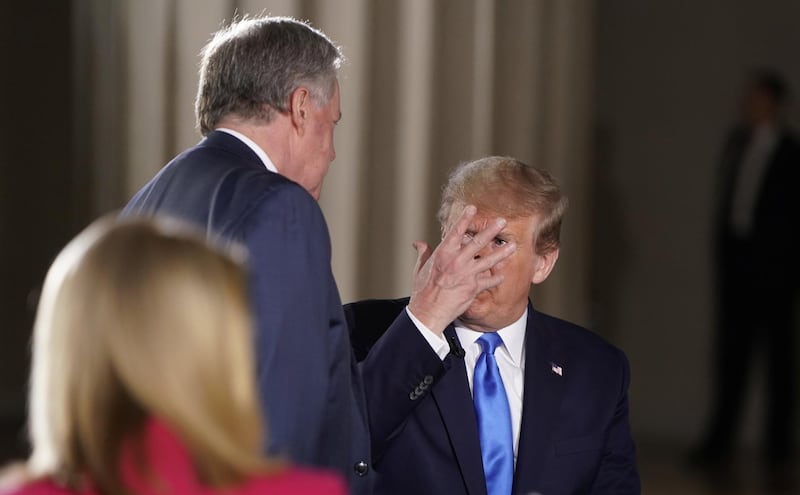 US President Donald Trump consults with White House chief of staff Mark Meadows. Reuters