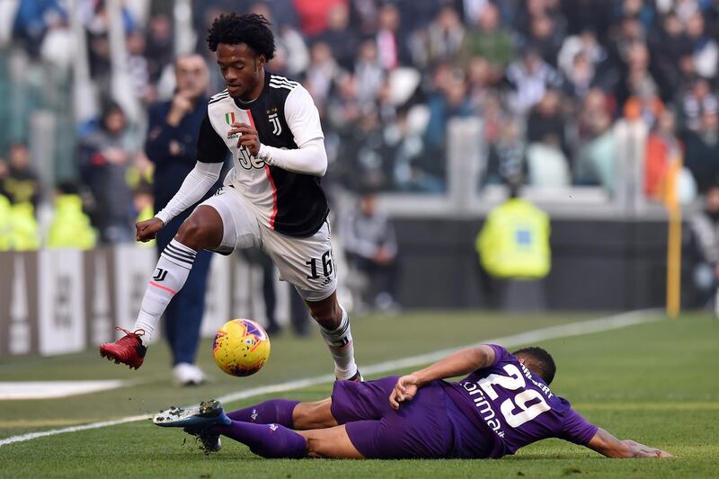Juan Cuadrado of Juventus is tackled by Dalbert of Fiorentina in Turin. Getty Images
