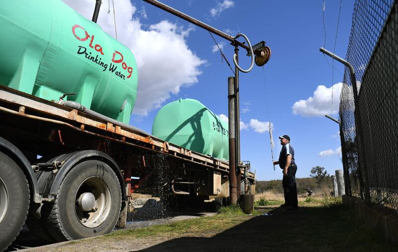 Water carrier Andrew Pearce fills his tanker with potable water at a council depot in the regional Queensland town of Stanthorpe. AFP