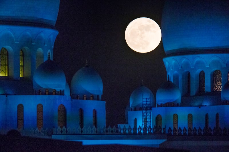 The supermoon rises behind Sheikh Zayed Grand Mosque in November 2016. Christopher Pike / The National