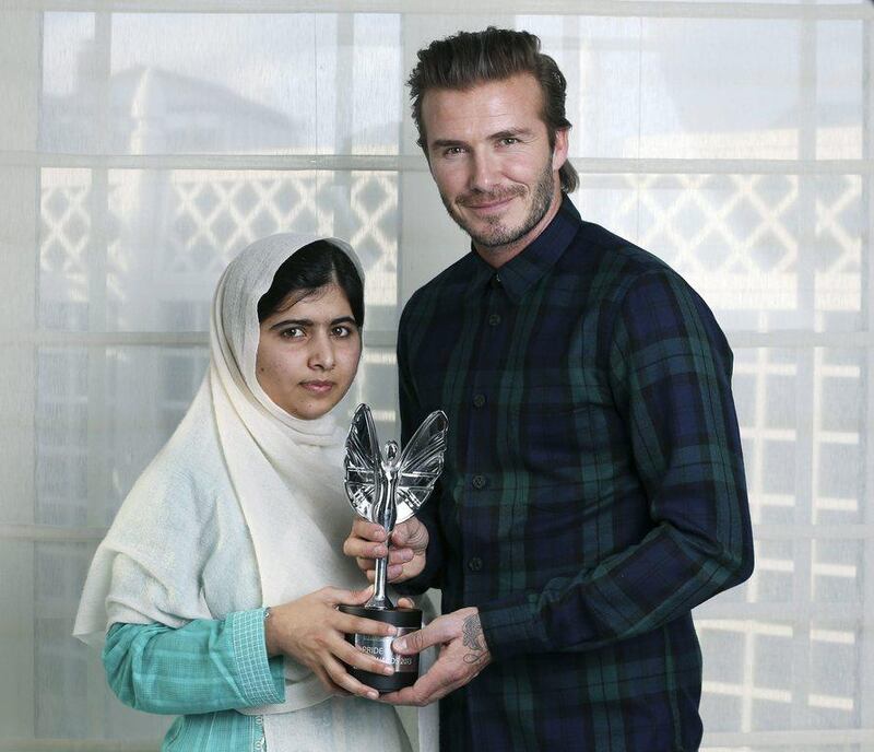 Malala Yousafzai won other awards, pictured here on October 7, 2013, by the Daily Mirror newspaper, David Beckham presents a Mirror Pride of Britain Teenager of Courage Award to Malala. Philip Coburn, Daily Mirror / AP Photo