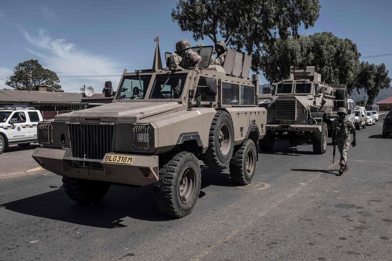 South African National Defence Force (SANDF) soldiers drive in an Armoured Personnel Carrier (APC) in the Cape Flats area of Cape Town during a patrol to enforce the 21-day nationwide lockdown in South Africa.  AFP