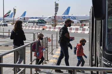 Passengers board a shuttle bus at Dubai International Airport as Emirates resumed a limited number of outbound passenger flights. Emirates, Etihad, Flydubai and Air Arabia are operating repatriation flights from the UAE.  AFP