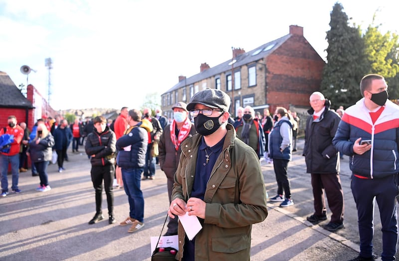 A Barnsley fan is seen waiting outside the stadium prior to the Championship play-off semi-final between Barnsley and Swansea City at Oakwell Stadium. Getty