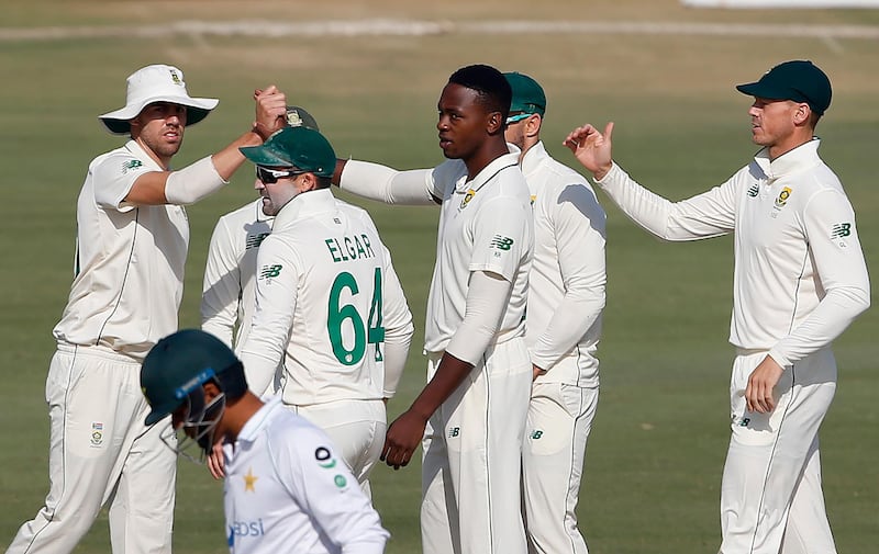 Kagiso Rabada, centre, celebrates with his South Africa teammates after taking the wicket of Pakistan's Hasan Ali for 21. AP