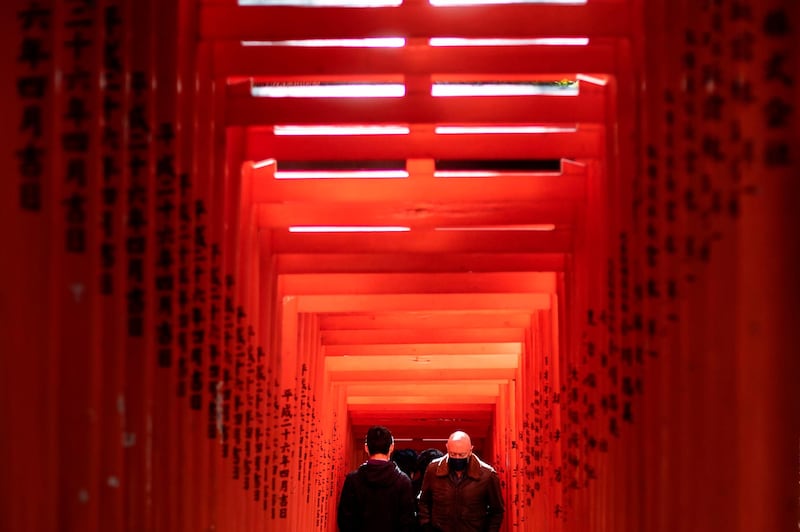 People walk along a row of gates at Hie Shrine in Tokyo. AFP
