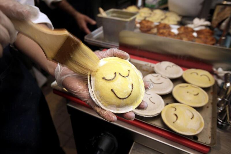 A baker brushes on a glaze on pies before baking at Pie Face in New York. Pie Face has 665 outlets signed up for expansion across Japan, South Korea and the Philippines. Richard Drew / AP Photo