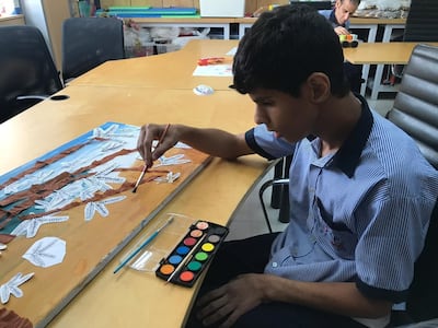 Children from Senses painting a Ghaf tree to be made into a carpet for Dubai Design Week. Courtesy Hands