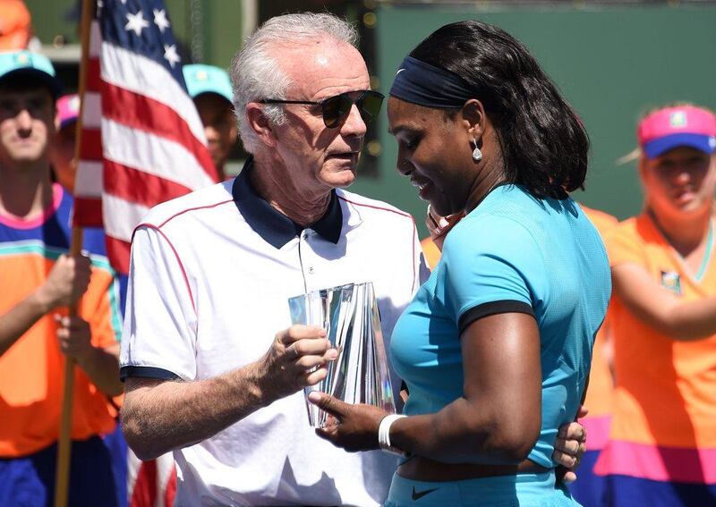 Indian Wells Tennis Garden CEO Raymond Moore, left, presents the second place trophy to Serena Williams of USA after the women's final of the BNP Paribas Open at the Indian Wells Tennis Garden in Indian Wells, California, March 20, 2016. Moore resigned on Monday after coming under heavy fire for saying women's tennis "ride(s) on the coat-tails of the men".