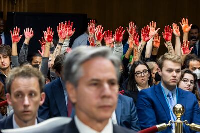 Protesters raise their arms and call for a ceasefire in Gaza during a Senate hearing on aid where US Secretary of State Antony Blinken was speaking, in Washington on October 31. EPA