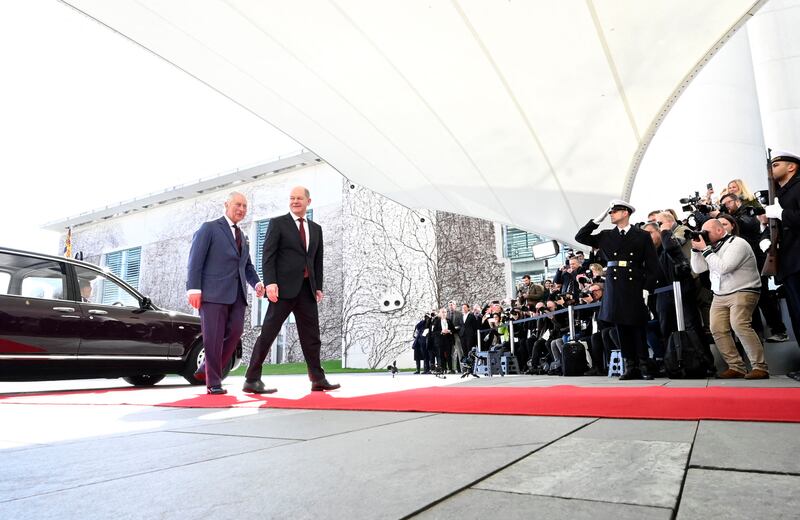 Mr Scholz and the king make their way into the Chancellery in Berlin. AFP