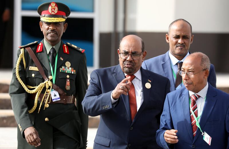 Sudan's President Omar al-Bashir walks with officials as he leaves the African Union (AU) summit in Nouakchott, Mauritania, July 2, 2018.  Ludovic Marin/Pool via Reuters