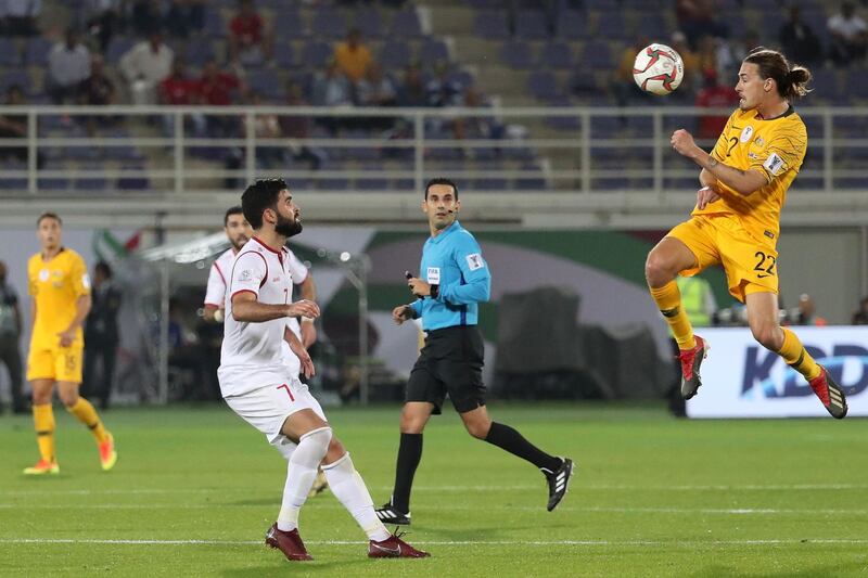 Khrbin, left,  fights for the ball against Australia's Jackson Irvine. AFP