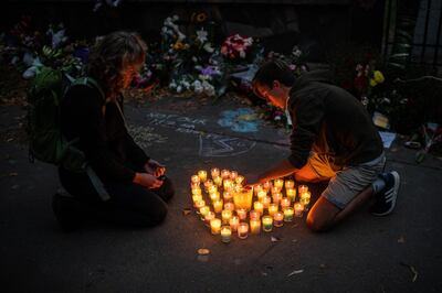 CHRISTCHURCH, NEW ZEALAND - MARCH 17: People light candles next to flowers and tributes laid by the wall of the Botanic Gardens on March 17, 2019 in Christchurch, New Zealand. 50 people are confirmed dead, with 36 injured still in hospital following shooting attacks on two mosques in Christchurch on Friday, 15 March. 41 of the victims were killed at Al Noor mosque on Deans Avenue and seven died at Linwood mosque. Another victim died later in Christchurch hospital. A 28-year-old Australian-born man, Brenton Tarrant, appeared in Christchurch District Court on Saturday charged with murder. The attack is the worst mass shooting in New Zealand's history. (Photo by Carl Court/Getty Images) ***BESTPIX***
