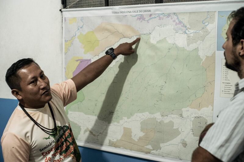 Bushe Matis, co-ordinator of Univaja, the main indigenous organisation from the country's north-western region, talks with Thiago Arruda Mairum, an official from the Indigenous Working Center (CTI), a Brazilian NGO that defends indigenous people in Amazonia. AFP