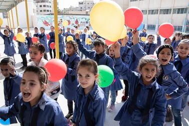 epa07809802 Students wave balloons for the arrival of the Commissioner-General of the United Nations Relief and Works Agency for Palestine Refugees in the Near East (UNRWA) Pierre Krahenbuhl at Nuzha Girls School, in Amman, Jordan, 01 September 2019. Krahenbuh visited the school during the first day of Back to School activities at UNRWA schools in Jordan. EPA/ANDRE PAIN