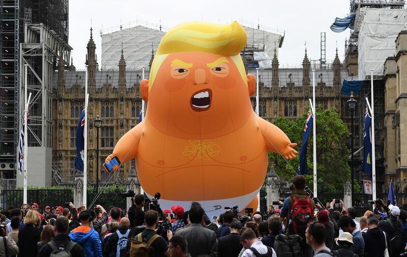 Anti-Trump protesters with a Trump baby blimp flying over Parliament Square gather for a protest against US President Donald Trump's State visit to the UK.  EPA