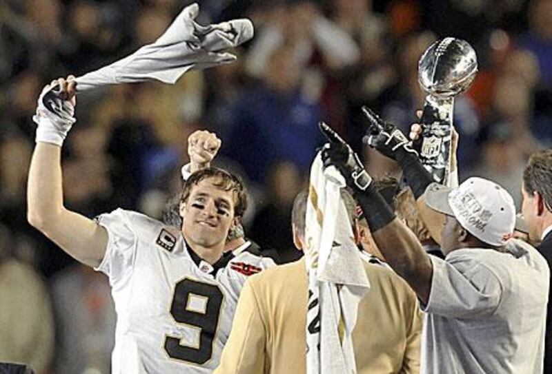The quarterback Drew Brees celebrates during the presentation of the Vince Lombardi trophy after defeating the Indianapolis Colts in the Super Bowl XLIV.