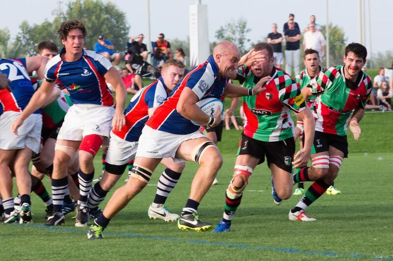 The Jebel Ali Dragons, in blue, again denied their rivals the Abu Dhabi Harlequins at title as they went on  to win the West Asia Cup. Duncan Chard for the National