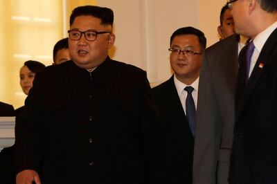 North Korean leader Kim Jong Un's sister Kim Yo Jong, left, is seen in the background as the North Korean leader arrives to meet with Singapore's Prime Minister Lee Hsien Loong at the Istana or presidential palace on Sunday, June 10, 2018, in Singapore. (AP Photo/Wong Maye-E)