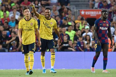 Arsenal's Gabonese striker Pierre-Emerick Aubameyang (C) celebrates after scoring the opening goal during the 54th Joan Gamper Trophy friendly football match between Barcelona and Arsenal at the Camp Nou stadium in Barcelona on August 4, 2019.  / AFP / Josep LAGO

