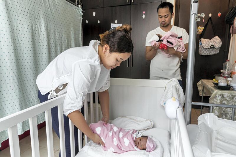 DUBAI, UNITED ARAB EMIRATES. 16 MARCH 2021. Parents John and Monica Pentio Tubo who have recently given birth to twins have been re-united with their daughters after a benefactor came foward and paid their outstanding hospital bills. The couple is shown here in the small room they share with with other people where they have made arrangements for the arrival of the twins. (Photo: Antonie Robertson/The National) Journalist: Patrick Ryan. Section: National.