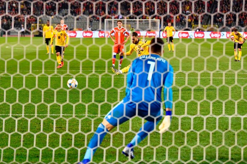 Hazard scores a penalty kick past Russia's goalkeeper Guilherme. AFP