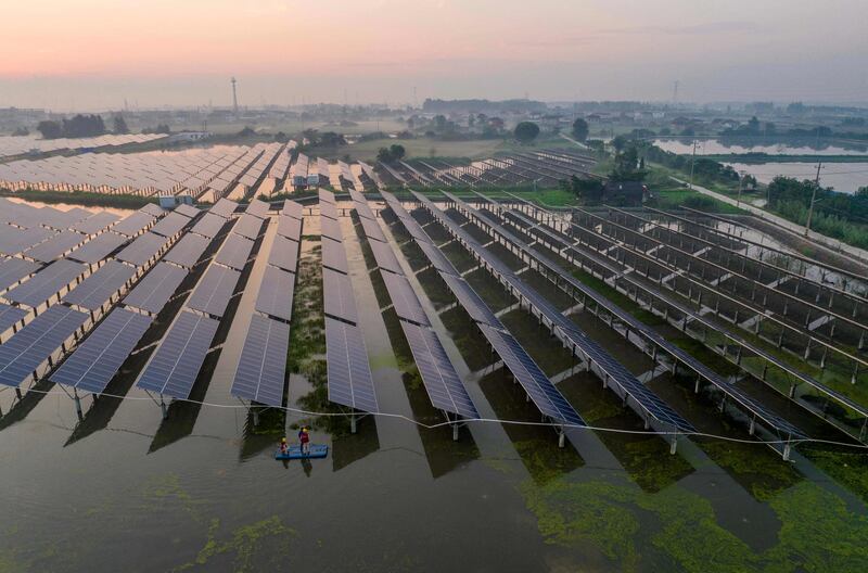 Workers inspect solar panels in Taizhou, in China’s Jiangsu province. AFP