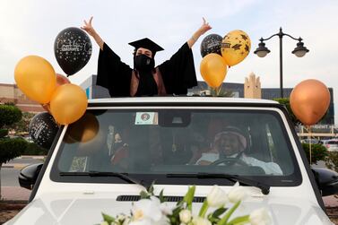 Ajman, United Arab Emirates - Reporter: Anam Rizvi. News. Andalus Abdulwahhab celebrates out the sunroof of her car before her drive through graduation from Ajman University because of Covid-19. Wednesday, February 10th, 2021. Ajman. Chris Whiteoak / The National