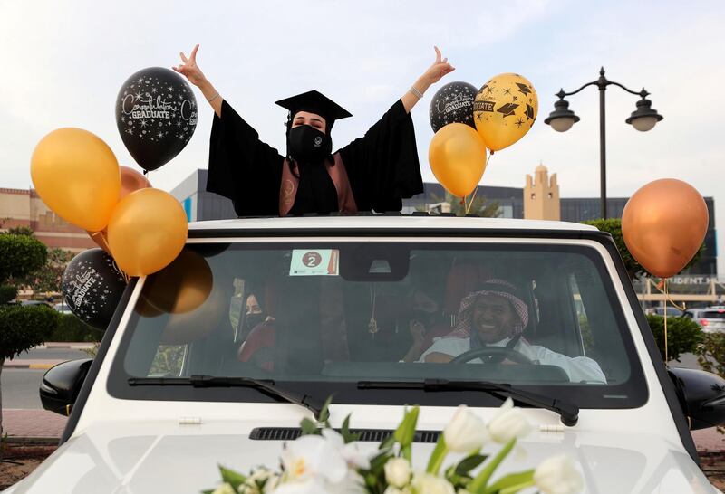 Ajman, United Arab Emirates - Reporter: Anam Rizvi. News. Andalus Abdulwahhab celebrates out the sunroof of her car before her drive through graduation from Ajman University because of Covid-19. Wednesday, February 10th, 2021. Ajman. Chris Whiteoak / The National