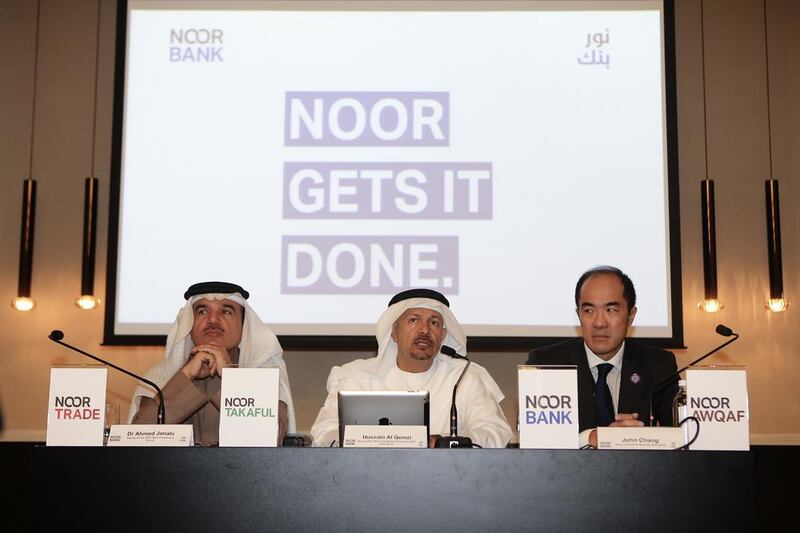 Ahmed Janahi, deputy group CEO of Noor Investment Group, Hussain Al Qemzi, CEO of Noor Bank, speak at a press conference announcing the company's rebranding.  Sarah Dea / The National

