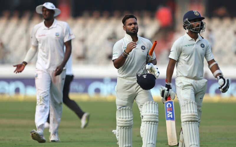 Indian cricketer Rishabh Pant and Ajinkya Rahane, right, walk off the field at the end of the second day of the second cricket test match between India and West Indies in Hyderabad, India, Saturday, Oct. 13, 2018. (AP Photo/Mahesh Kumar A.)