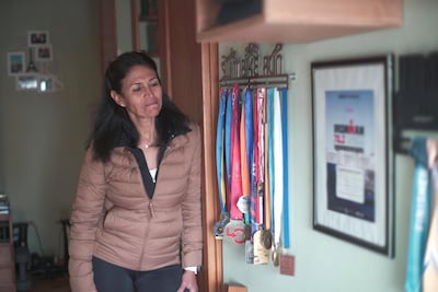 Amany Khalil with her marathon and triathlon medals
Mahmoud Nasr / The National