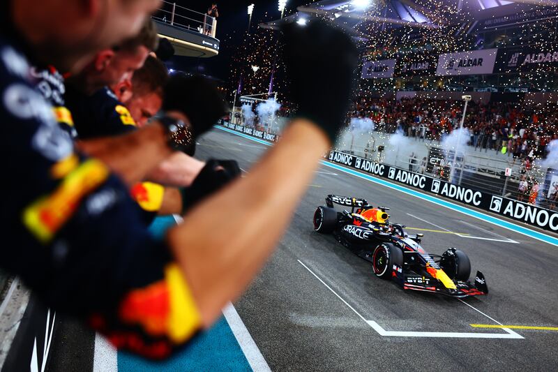 Red Bull's Max Verstappen takes the chequered flag to win the Abu Dhabi Grand Prix. Getty Images